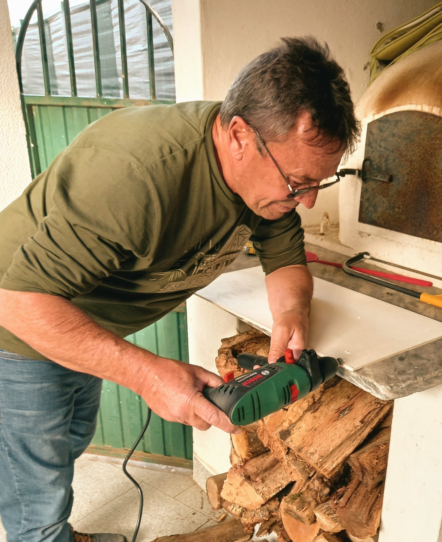 Wayne Fletcher working with a power tool on a home project